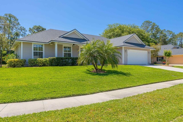 301 Graciela Cir, Saint Augustine, FL 32086 - single story home featuring an attached garage, driveway, a front lawn, and roof with shingles