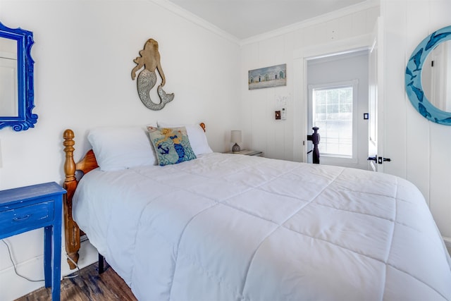 bedroom with crown molding, dark hardwood / wood-style flooring, and wood walls