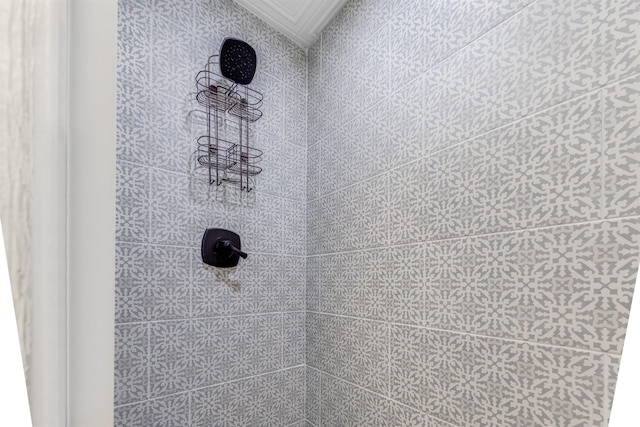 interior details featuring tiled shower