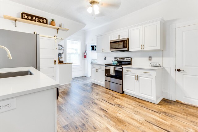 kitchen featuring backsplash, sink, white cabinets, and stainless steel appliances