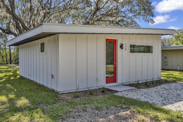 view of outbuilding with a yard