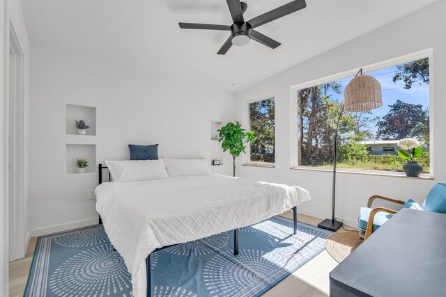 bedroom with light hardwood / wood-style floors and ceiling fan