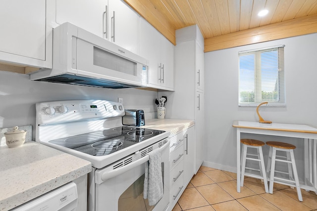 kitchen with white appliances, wood ceiling, white cabinets, light tile patterned floors, and recessed lighting