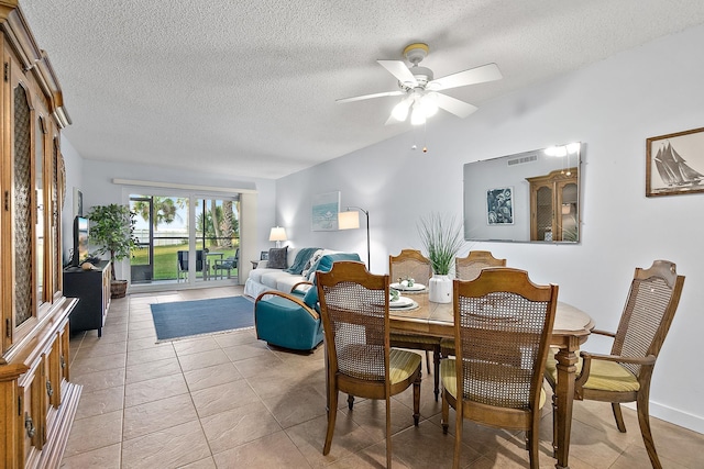 dining space with ceiling fan and a textured ceiling