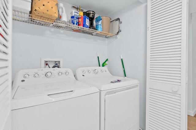 clothes washing area with independent washer and dryer
