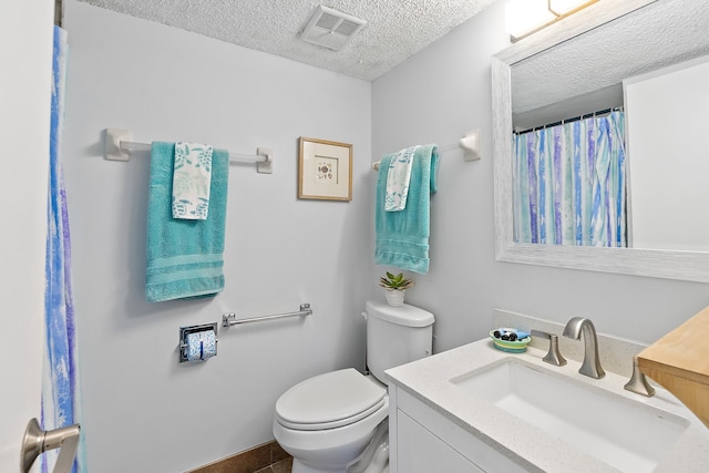 full bathroom with a textured ceiling, toilet, vanity, and curtained shower