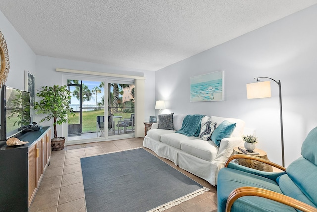living room featuring a textured ceiling and light tile patterned flooring