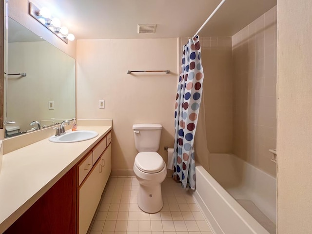 full bathroom with tile patterned flooring, shower / bath combo, vanity, and toilet