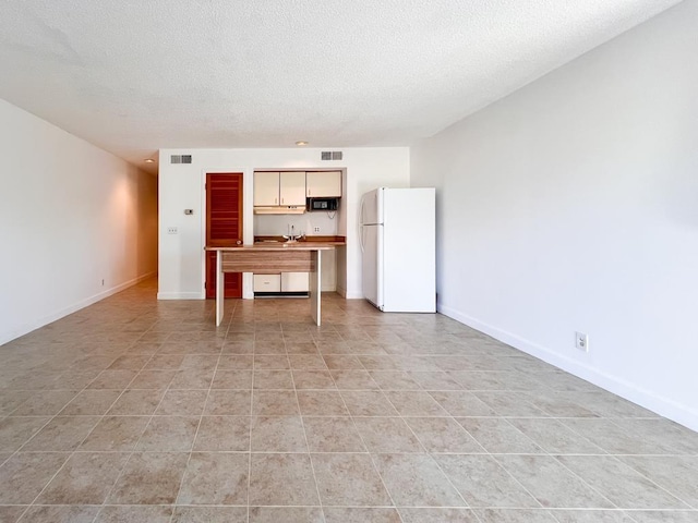 unfurnished living room with a textured ceiling