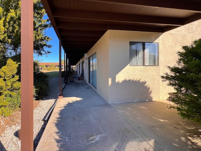 view of home's exterior with a patio and stucco siding