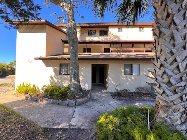 rear view of house featuring a balcony