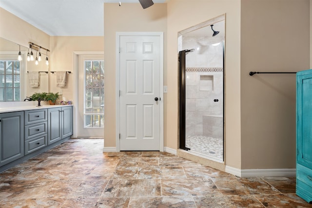 5525 Saint Ambrose Church Rd, Elkton, FL 32033 - bathroom featuring vanity, healthy amount of natural light, a shower stall, and ceiling fan