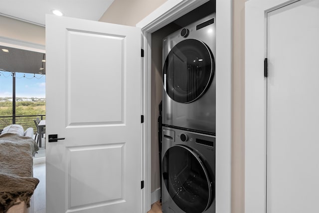 washroom featuring stacked washer and dryer