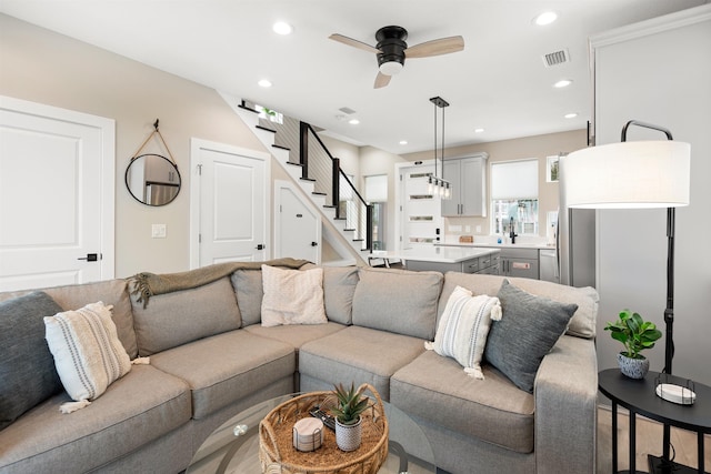 living room featuring sink and ceiling fan