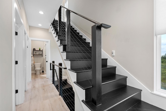 stairs featuring hardwood / wood-style floors