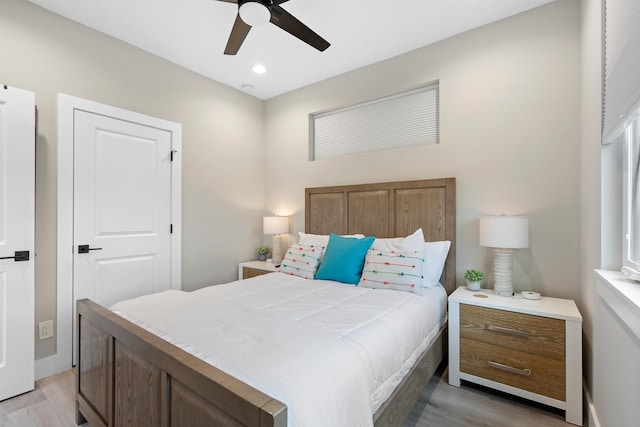 bedroom with light hardwood / wood-style floors and ceiling fan