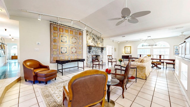40 Sandpiper Dr, Saint Augustine, FL 32080 - living area featuring rail lighting, ceiling fan, a stone fireplace, and light tile patterned flooring
