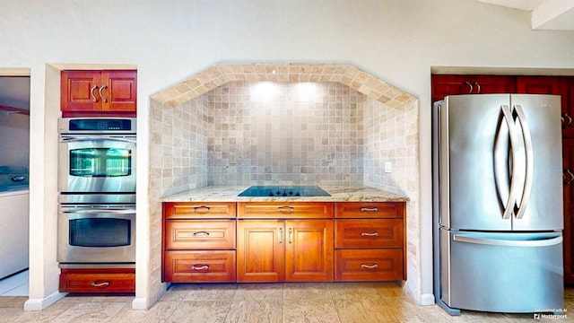 40 Sandpiper Dr, Saint Augustine, FL 32080 - kitchen with appliances with stainless steel finishes, light stone countertops, baseboards, and brown cabinets