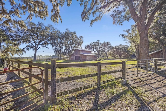 view of yard with a rural view and an outbuilding