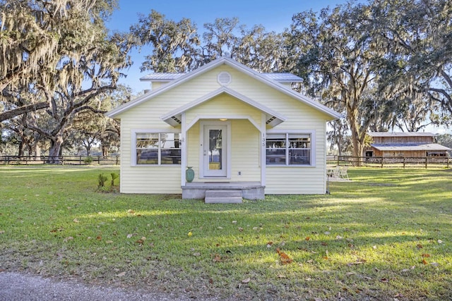 bungalow-style house featuring a front yard