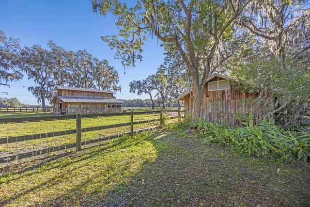 view of yard featuring an outbuilding and a rural view