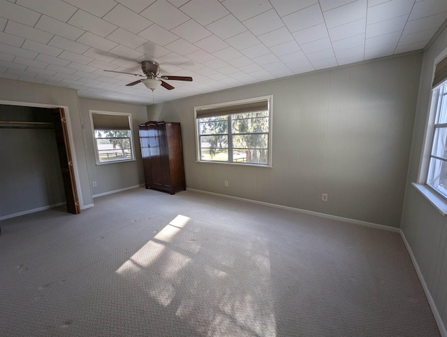 unfurnished bedroom with ceiling fan and light carpet