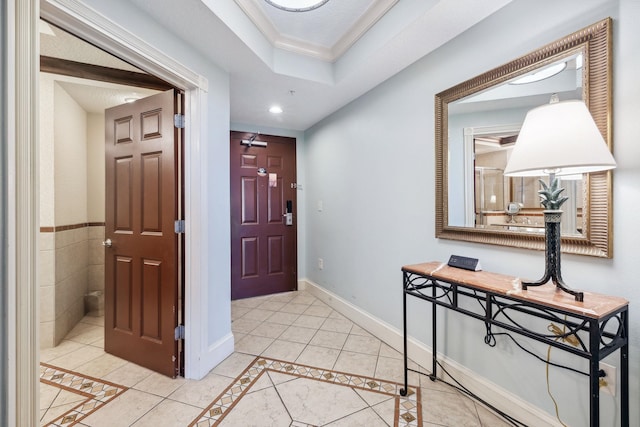 entryway featuring light tile patterned floors, baseboards, crown molding, a tray ceiling, and recessed lighting