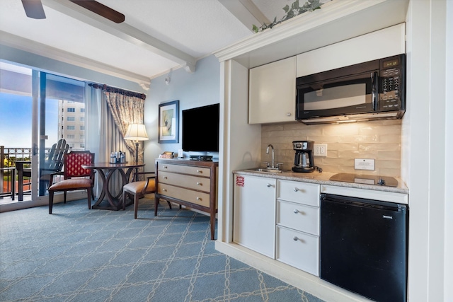 kitchen featuring white cabinets, a sink, beam ceiling, black appliances, and backsplash