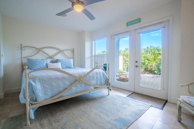 bedroom with access to outside, multiple windows, ceiling fan, and french doors