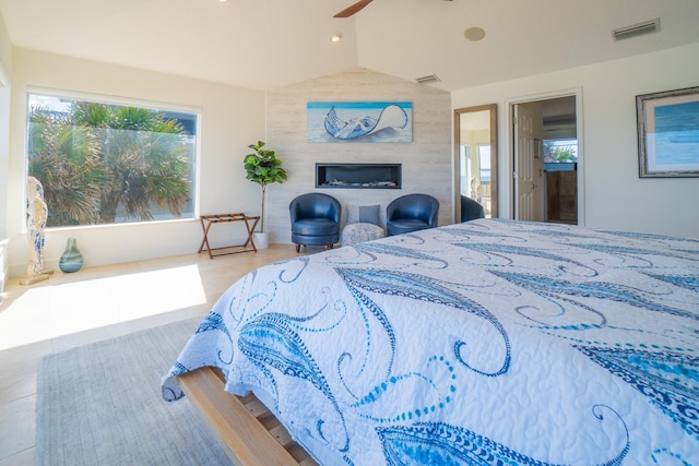 bedroom featuring ceiling fan, lofted ceiling, and connected bathroom