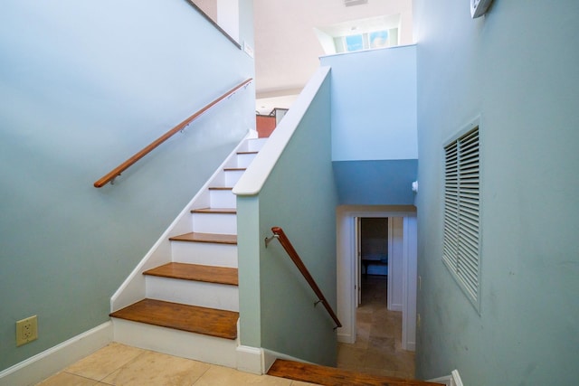 stairs with tile patterned floors