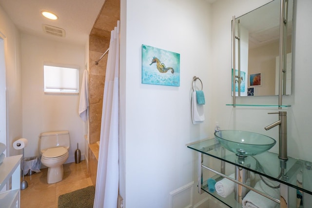 full bathroom with sink, tile patterned flooring, shower / tub combo with curtain, and toilet