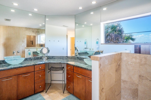 bathroom featuring vanity and a shower