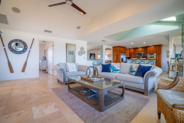 living room with ceiling fan and lofted ceiling