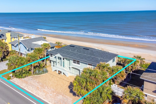 bird's eye view featuring a water view and a beach view