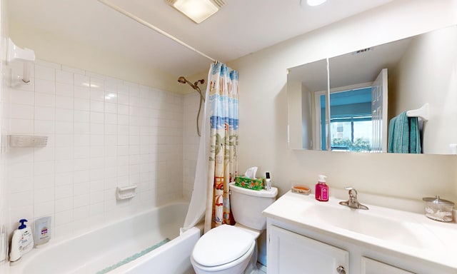 - bathroom featuring toilet, shower / bath combo with shower curtain, and vanity