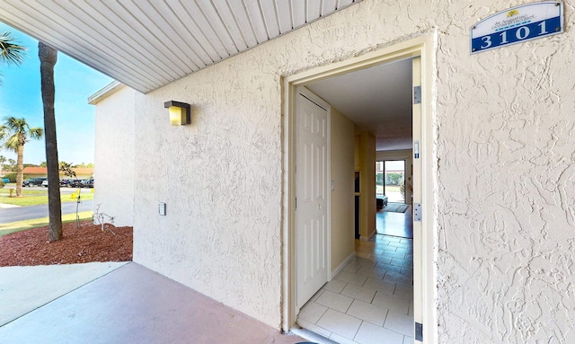  - entrance to property featuring stucco siding