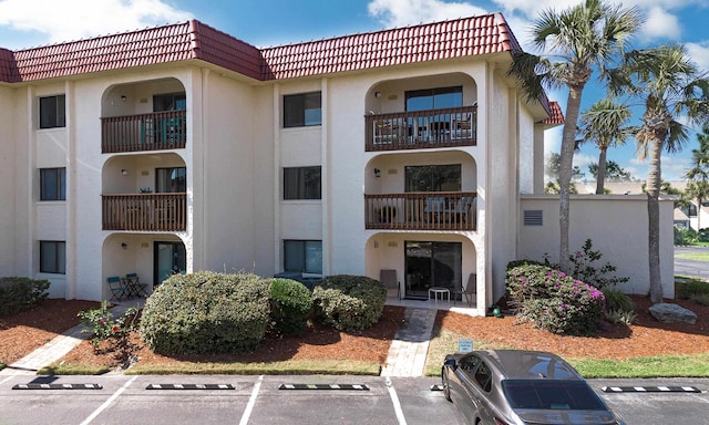  - view of property with uncovered parking