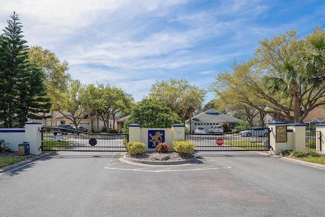 209 Lions Gate Dr, Saint Augustine, FL 32080 - view of street with a gated entry, a gate, and curbs