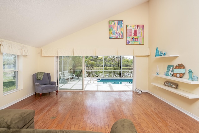 209 Lions Gate Dr, Saint Augustine, FL 32080 - living area featuring baseboards, lofted ceiling, and wood finished floors