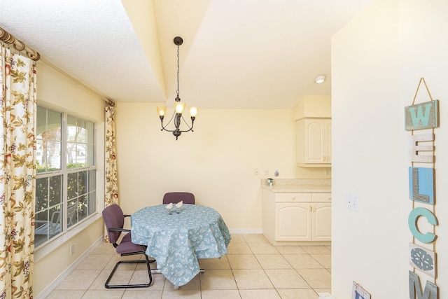 209 Lions Gate Dr, Saint Augustine, FL 32080 - dining space with baseboards, an inviting chandelier, a textured ceiling, and light tile patterned floors