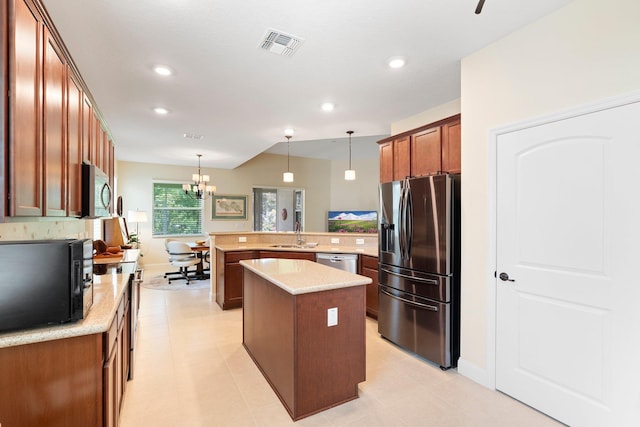 21 Park Place Cir, Palm Coast, FL 32164 - kitchen featuring stainless steel appliances, a peninsula, tasteful backsplash, a center island, and hanging light fixtures