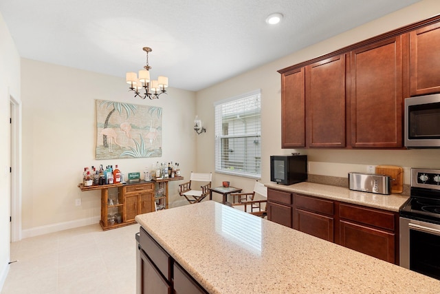 21 Park Place Cir, Palm Coast, FL 32164 - kitchen featuring appliances with stainless steel finishes, a chandelier, hanging light fixtures, light stone counters, and recessed lighting