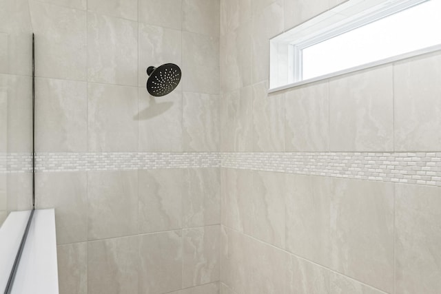 full bath with tiled shower