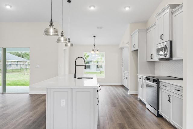 kitchen with a sink, stainless steel appliances, a wealth of natural light, and light countertops