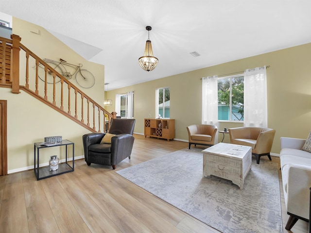 10 Seminole Dr, Saint Augustine, FL 32084 - living room with stairs, wood finished floors, a chandelier, and baseboards
