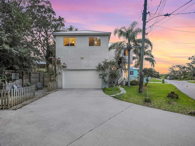 10 Seminole Dr, Saint Augustine, FL 32084 - view of front facade with stucco siding, driveway, a garage, and metal roof