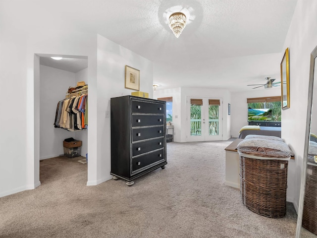 10 Seminole Dr, Saint Augustine, FL 32084 - bedroom with carpet flooring, access to outside, a walk in closet, baseboards, and a textured ceiling