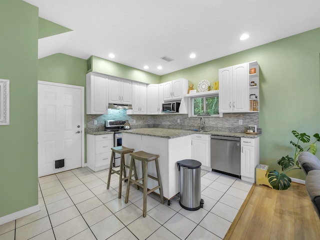10 Seminole Dr, Saint Augustine, FL 32084 - kitchen featuring appliances with stainless steel finishes, open shelves, a sink, white cabinets, and recessed lighting