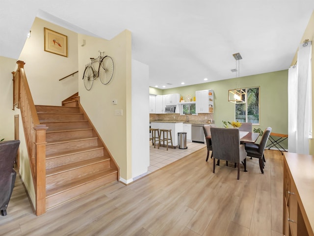 10 Seminole Dr, Saint Augustine, FL 32084 - dining area with light wood finished floors, stairway, and recessed lighting